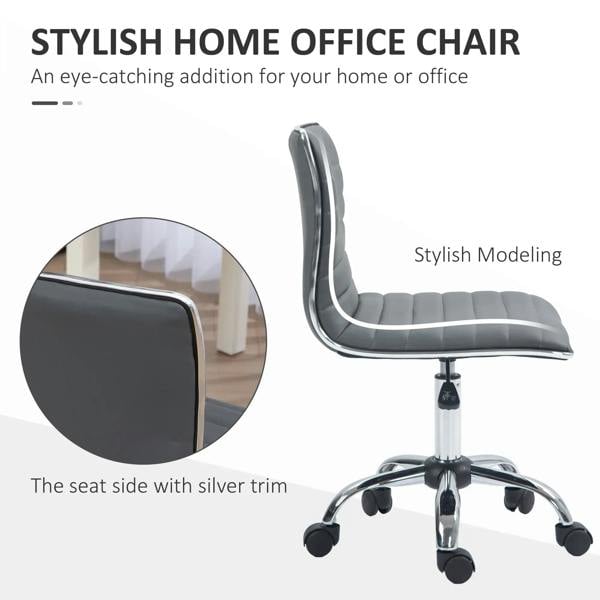 Armless task desk chair side view, dark grey faux leather with silver piping, swivel base
