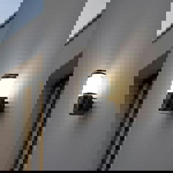 black outside wall lantern mounted on a white wall outside of a modern house