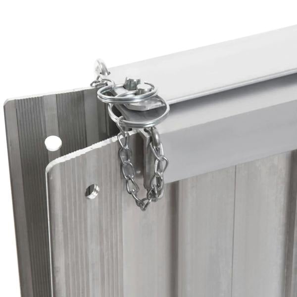 Silver safety latch and chain on folded aluminum wheelchair ramp