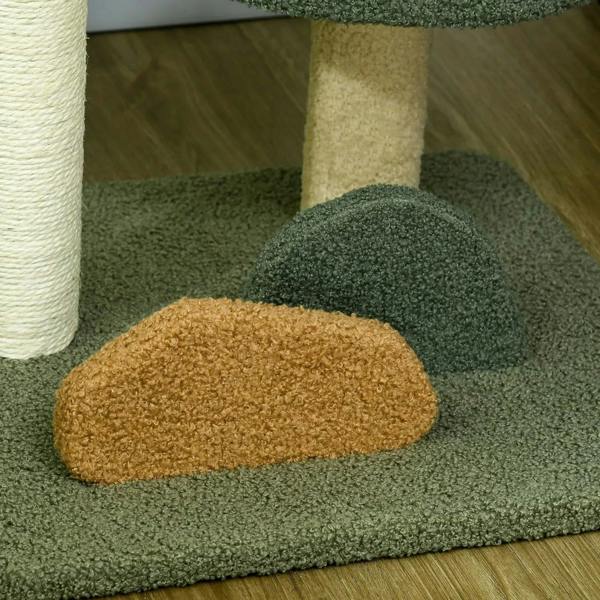 Close-up of beige scratch pad on dark green base mat of a small cat tree