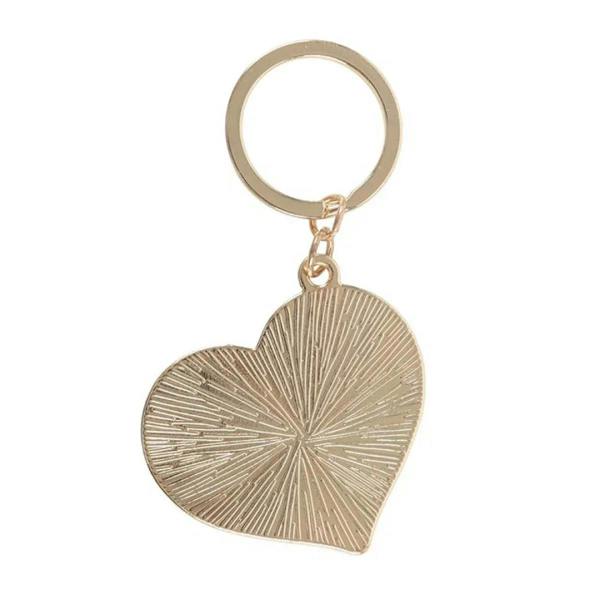 Gold heart keychain charm with textured ridged finish on a key ring