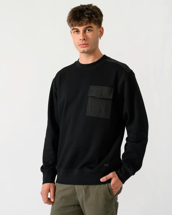 model wearing a BOSS Orange We Urban Mens Crew Neck Sweatshirt with Pocket in Black 001