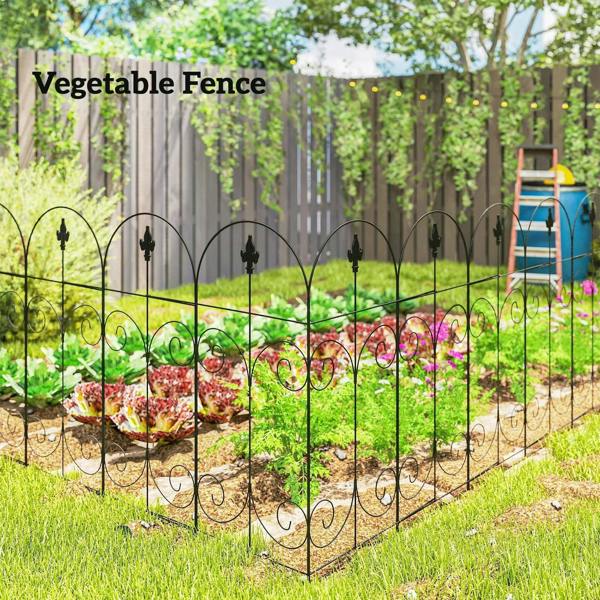Black metal vegetable garden fence with arched pickets and curved swirl details