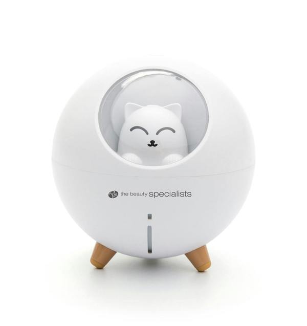 The Rio MIA Cat Childrens Essential Oil Diffuser, Humidifier, and Night Light features a round white design with three wooden legs, a smiling cat figurine in a clear window, and the beauty specialists printed on the front.