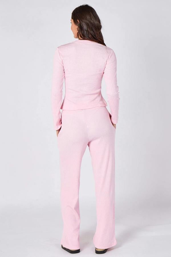 Person wearing a pink suit on a white background