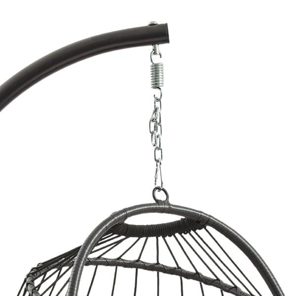 Black rattan hanging egg chair suspended from a curved metal frame, featuring a woven texture and stylish design for outdoor relaxation