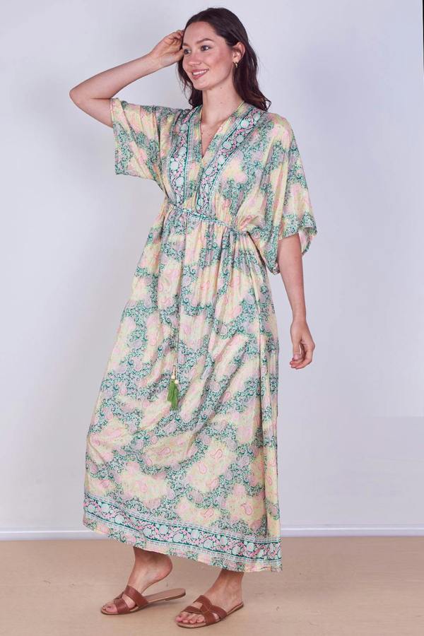Woman wearing a floral dress with a plain background