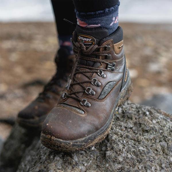 Women wearing the Grisport Quatro boot walking on rocks