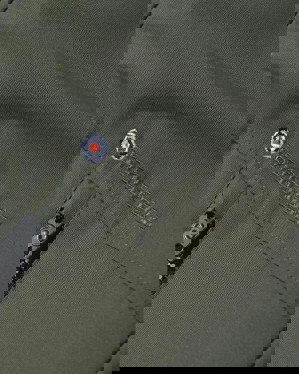 Lambretta Mens Utility Hooded Quilted Classic Badged Parka, close-up of the olive-green quilted fabric with embroidered Lambretta logo and zipped pocket.