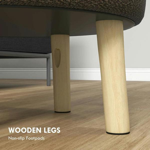 Brown round ottoman with light wood legs and padded underside