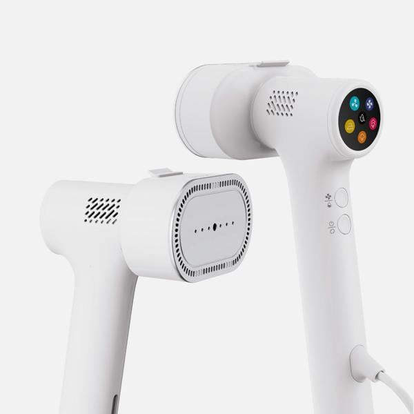 Two modern white Fridja f20 Handheld Clothes Steamer Pros are elegantly displayed against a plain white background—one showcases a perforated steam plate, while the other features a circular digital control panel with colorful icons. Perfect for those seeking an efficient portable steam iron or versatile handheld clothes steamer for everyday use.