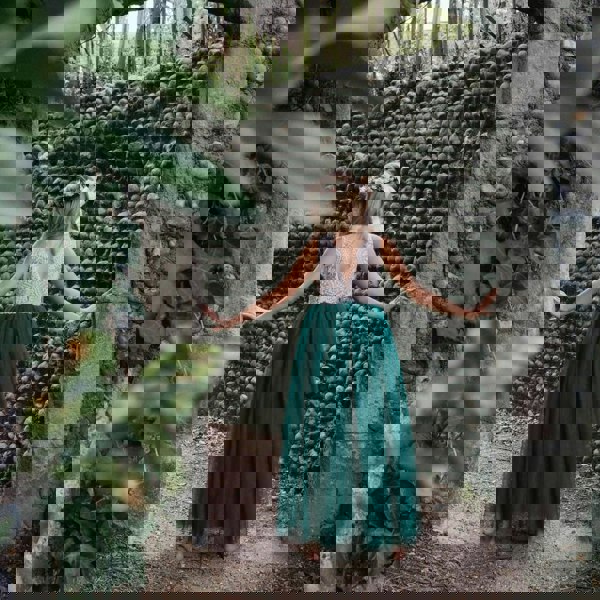 young girl walking away showing back of the flower girl dress 