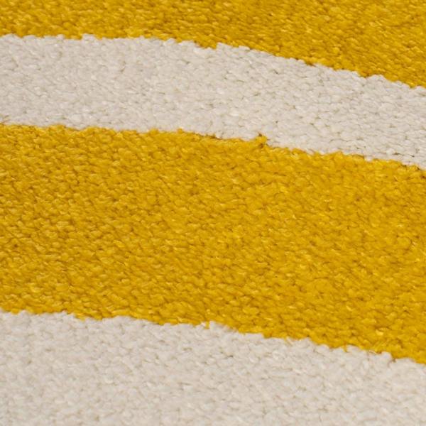Close-up of a textured surface with yellow and white stripes