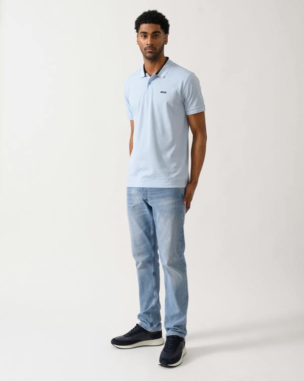 full length shot of a Model wearing a BOSS Green PL_Member Mens Short Sleeve Polo Shirt in Open Blue 460