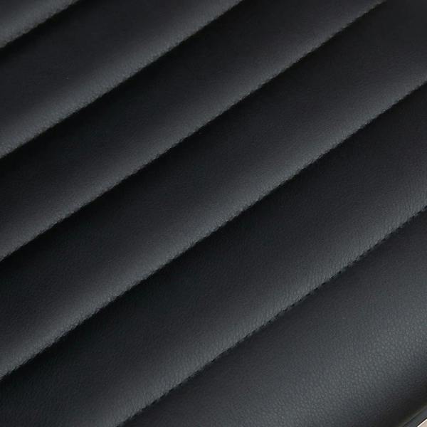 Black faux leather upholstery close-up with stitched panel texture.