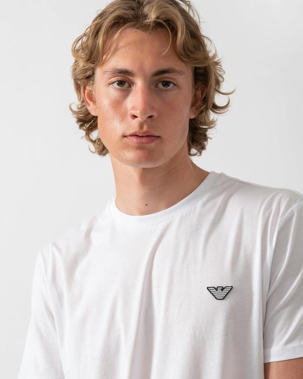 close up shot of a model wearing an Emporio Armani Mens Beach T-Shirt with Eagle Logo in White