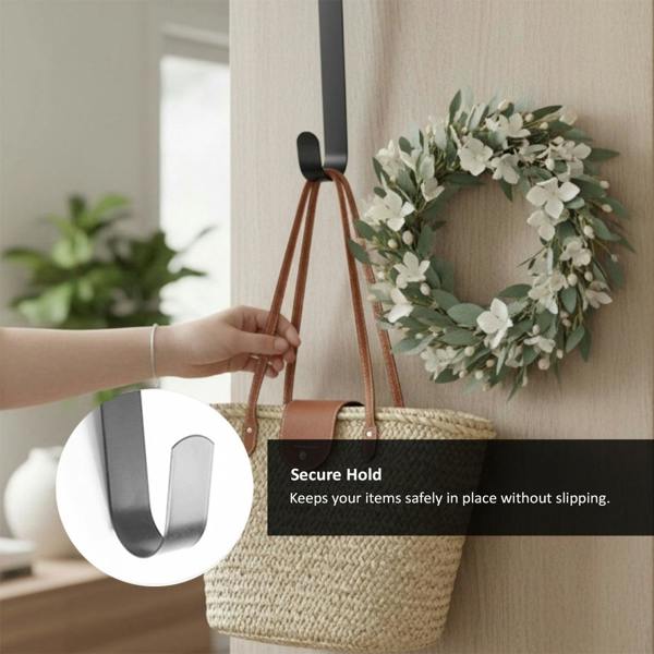 A hand holding a straw bag hanging on a grey metal wreath hook over a light wood door, with a decorative wreath beside it and text highlighting the secure, non-slip hold.