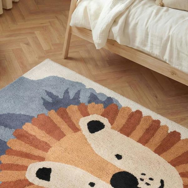 Children's rug with a hedgehog design on a wooden floor.