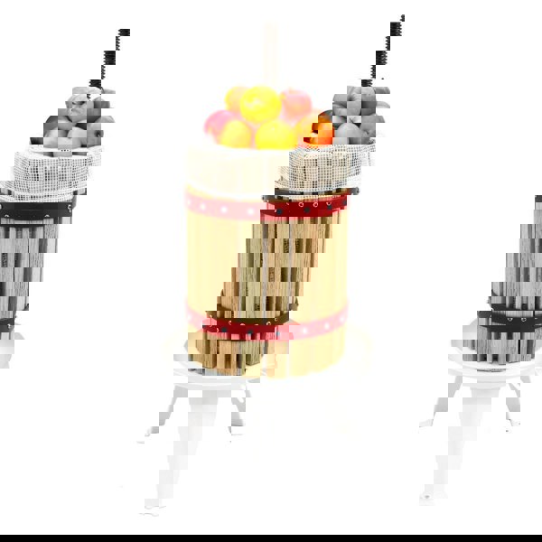 KuKoo 18 Litre Fruit Press with wooden slats, red metal bands, and a mesh top filled with fresh apples ready for juicing