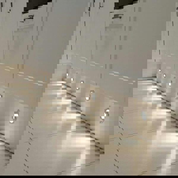 white LED plinth lights mounted along the white low level plinth in a kitchen 