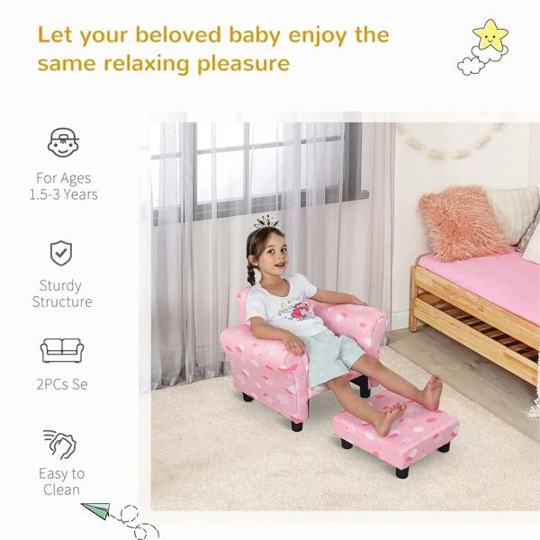 Pink cloud-pattern toddler armchair with pull-out ottoman, wide arms and dark legs