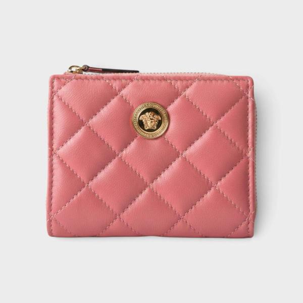 Supplied Fashion pink quilted leather wallet featuring a gold Medusa head emblem and zip closure.