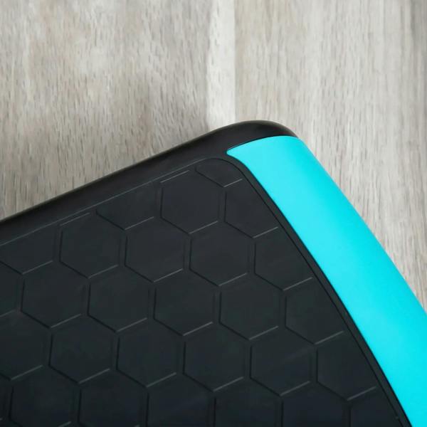 Textured non-slip aerobic step top with hex pattern and blue side trim