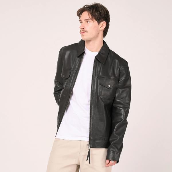 Image shows a man wearing a black real leather jacket with white tshirt. The jacket is unzipped.
