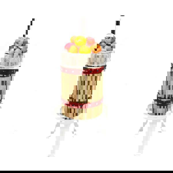 KuKoo 6 Litre Fruit Press with wooden slats, red metal bands, and a mesh top filled with fresh apples, ideal for juicing