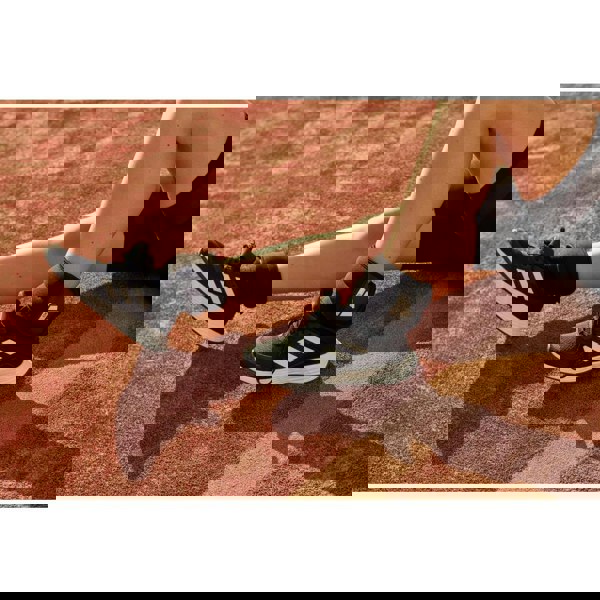 Person wearing black Adidas 1kg ankle/wrist weights