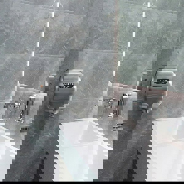 Maxblast Automatic Commercial Hand Dryer with HEPA Filter, sleek silver design mounted on a modern bathroom wall above a white sink