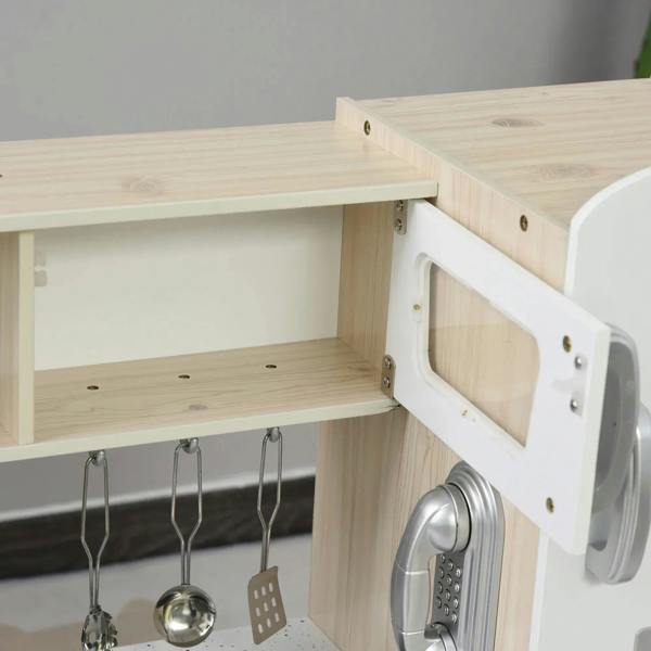 Close-up of kids wooden play kitchen cabinet with hinged door, interior shelf, and hanging utensils