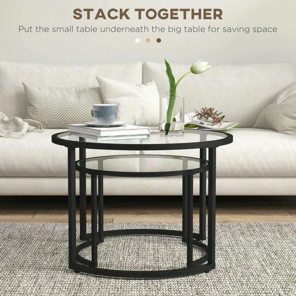 Black round glass-top coffee table with open lower frame for nesting under larger table.