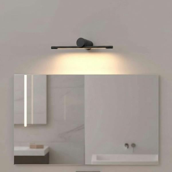 black small vanity mirror light mounted in a modern bathroom on the wall over a mirror