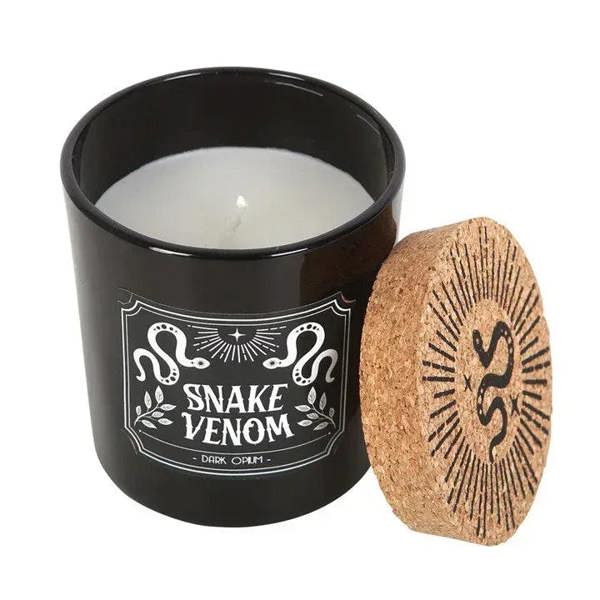 Black jar candle with open cork lid; white Snake Venom label on front