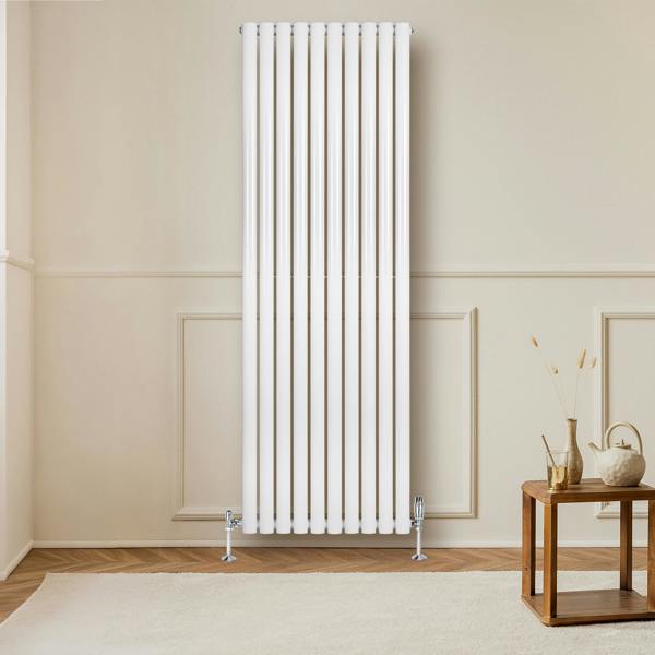 Sleek white oval single column radiator, 1800mm x 600mm, mounted on a wall in a modern room with wooden flooring and a decorative table