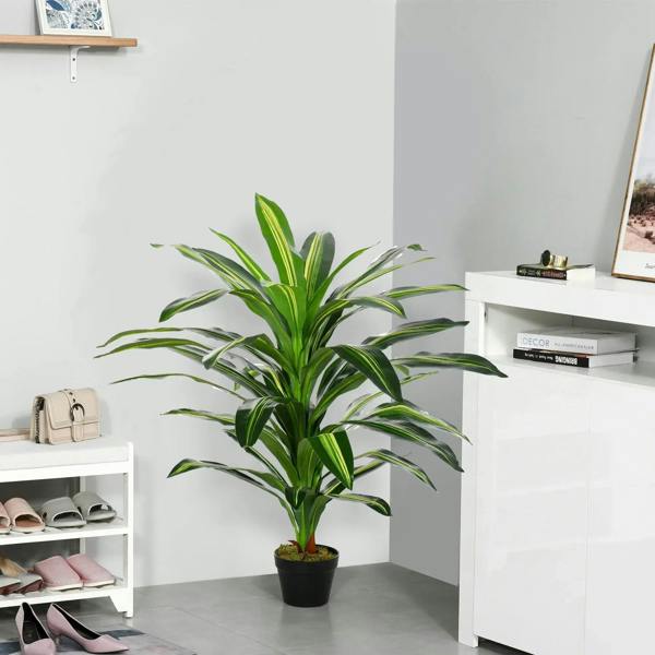Artificial green potted plant with tall spiky leaves in a black pot