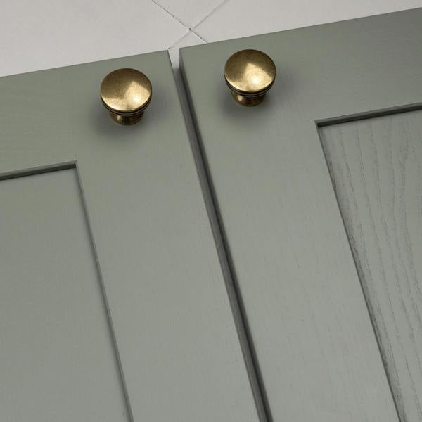 An antique brass round circular knob 