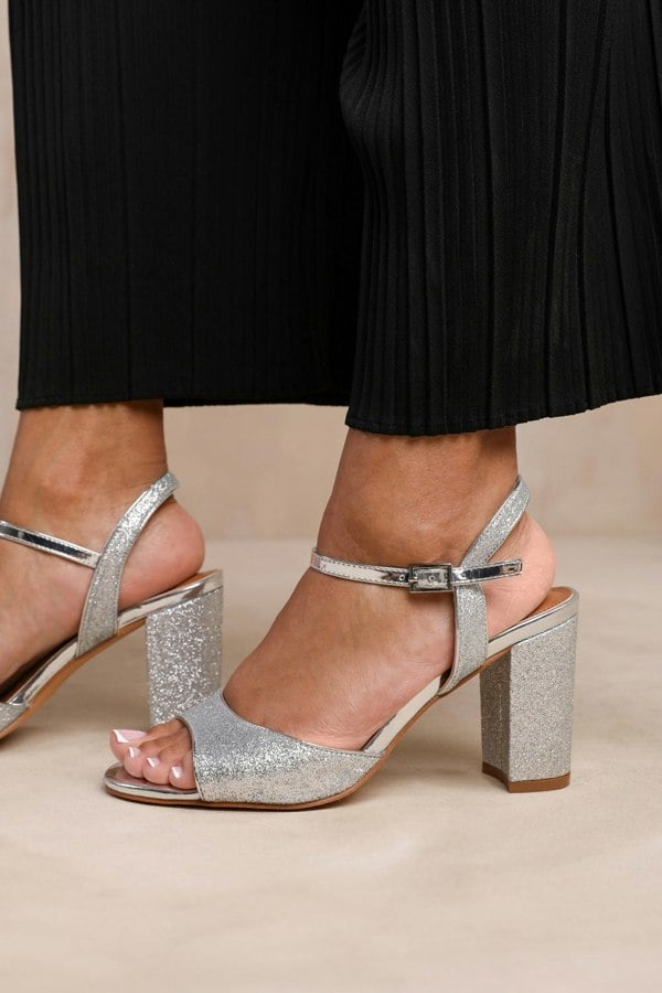 Where's That From Florence Wide Fit Mid High Heels With Ankle Strap in Silver Glitter