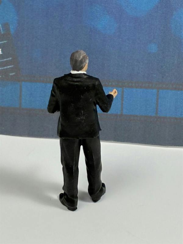 a miniature figure of a man in a suit