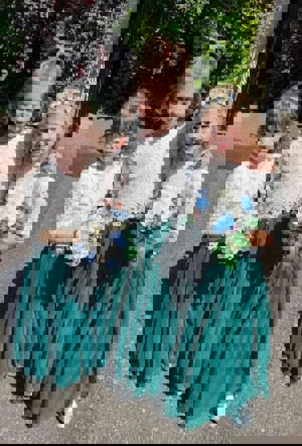 Young children holding bouquets 