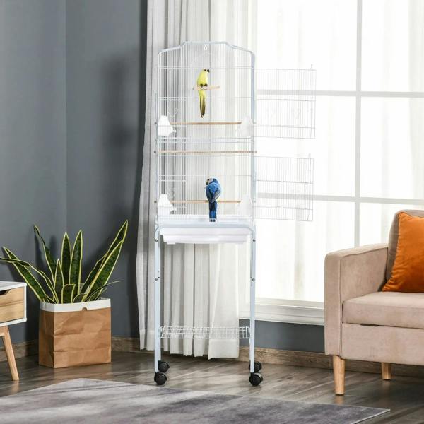White bird cage on wheeled stand with wooden perches and two birds