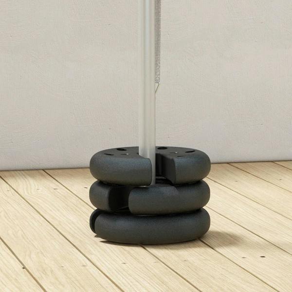 Dark gray tent leg base weight set stacked under a vertical canopy pole
