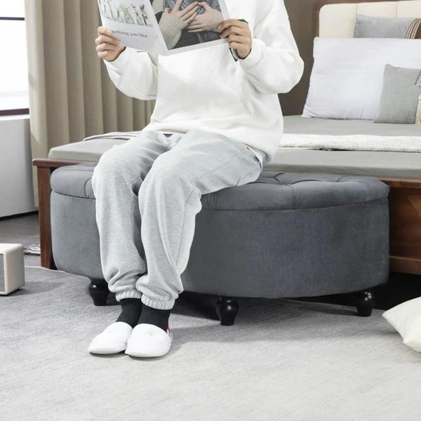 Dark grey velvet-feel storage ottoman bench with tufted seat and low legs