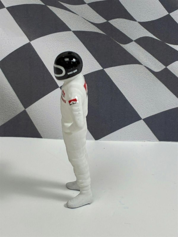 a toy figure in a white suit with a black helmet