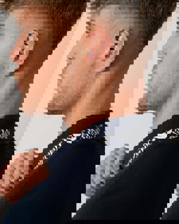 Model wearing Emporio Armani Mens Beach Polo in Armani Blue - Logo detail