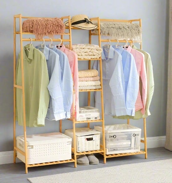 Heavy-duty bamboo clothes rail rack with corner storage shelves in natural wood finish

