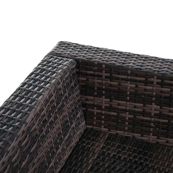 Corner close-up of dark brown rattan wicker weave on sofa frame