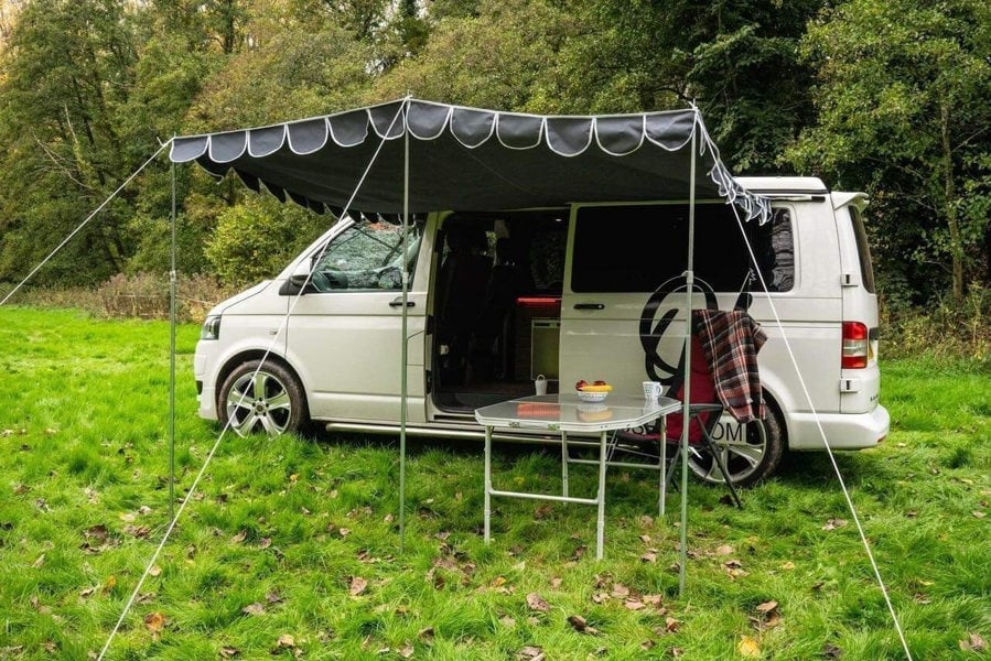 Charcoal Shade Campervan Canopy OLPRO on a camper van, providing cover from the sun