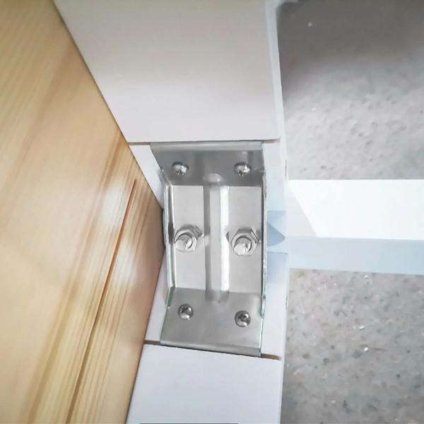 White table leg with exposed metal bracket and screws on underside